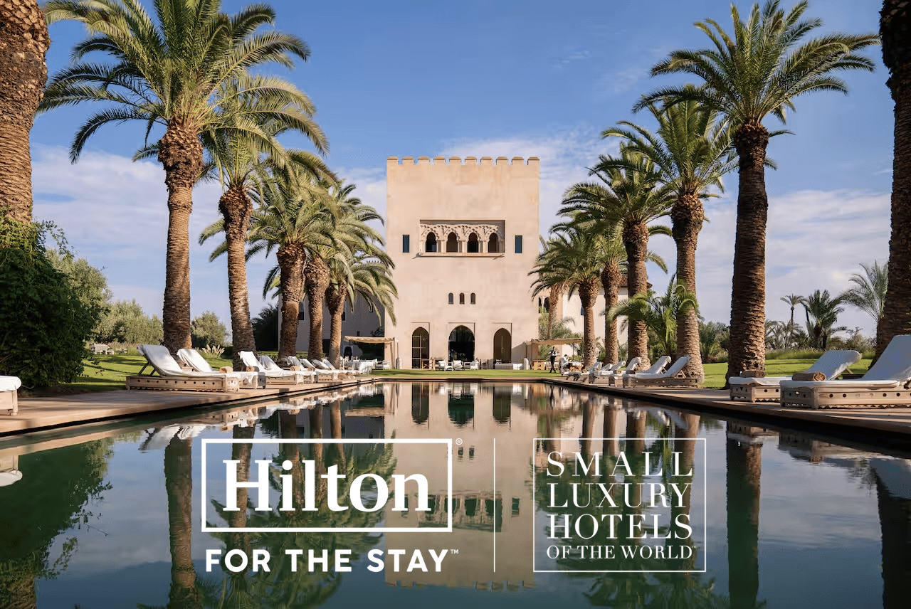 A photo of a hotel with the logos of Hilton and SLH