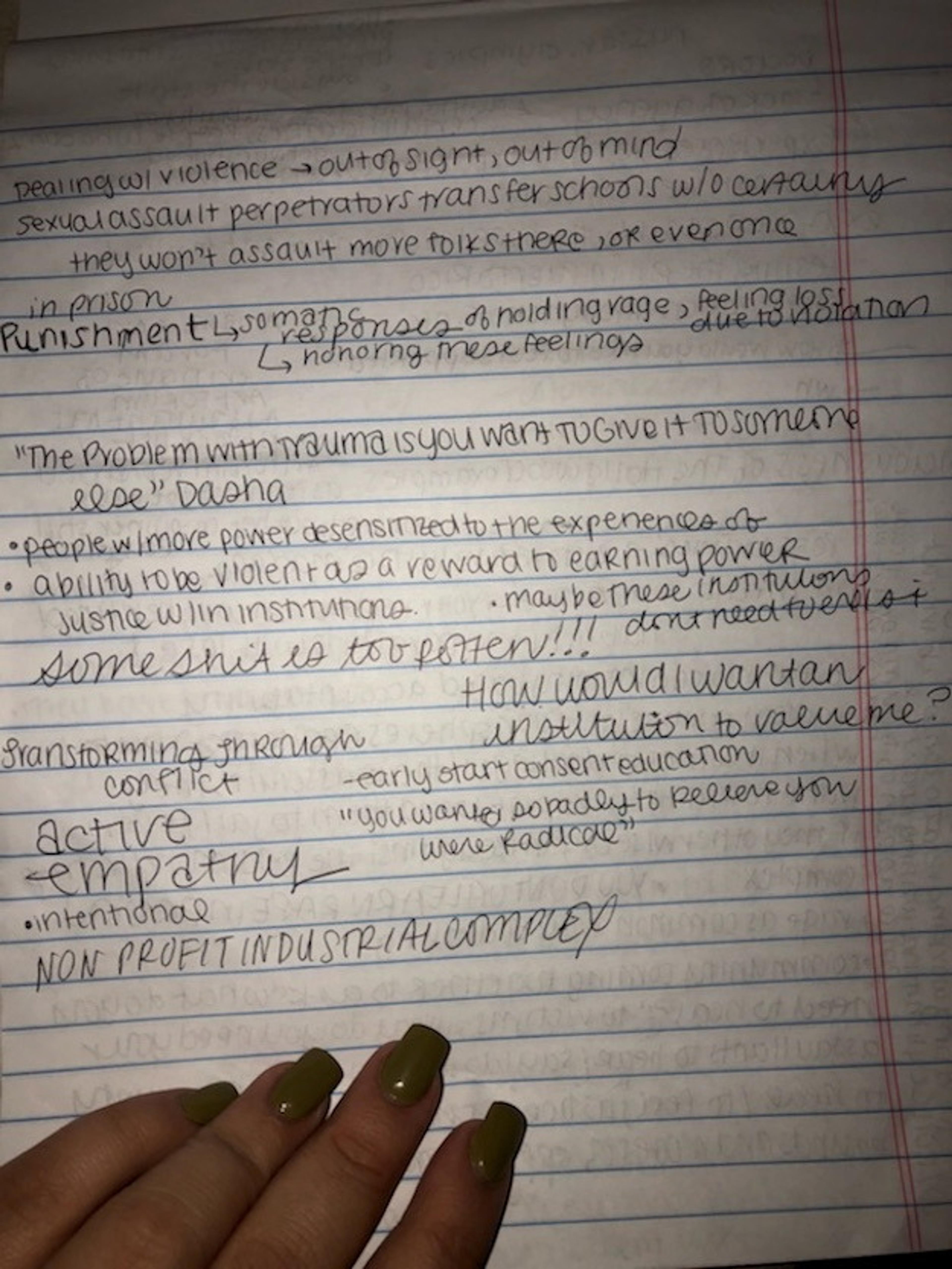 Photo of a hand with hand written notes from the event, one note says "active empathy," another reads "non profit industrial ocmplex" 