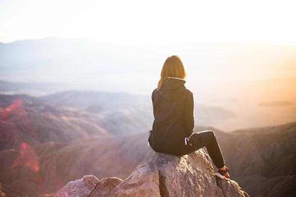 a woman sat on a mountain