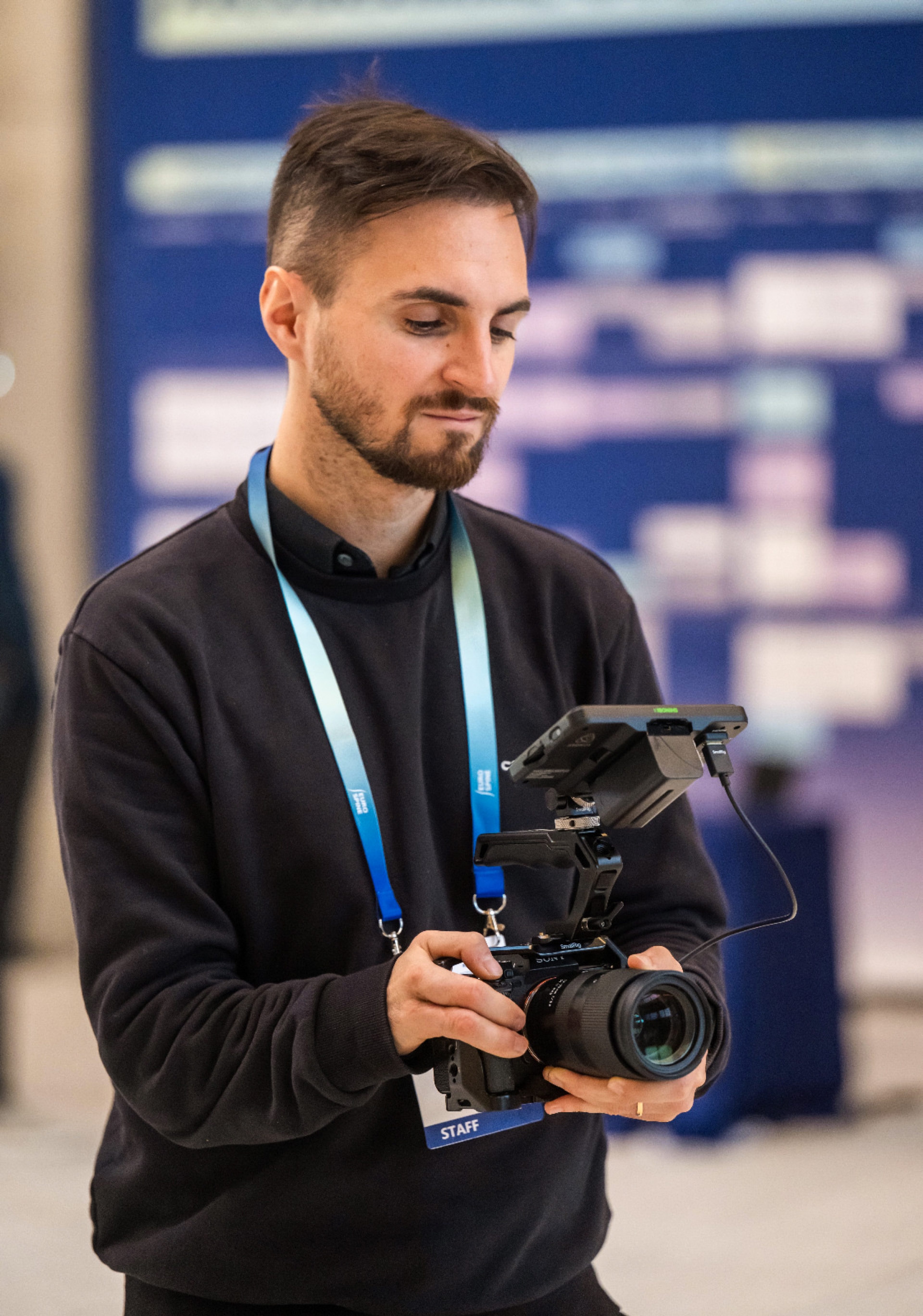 Camera operator checking a shot on the congress floor