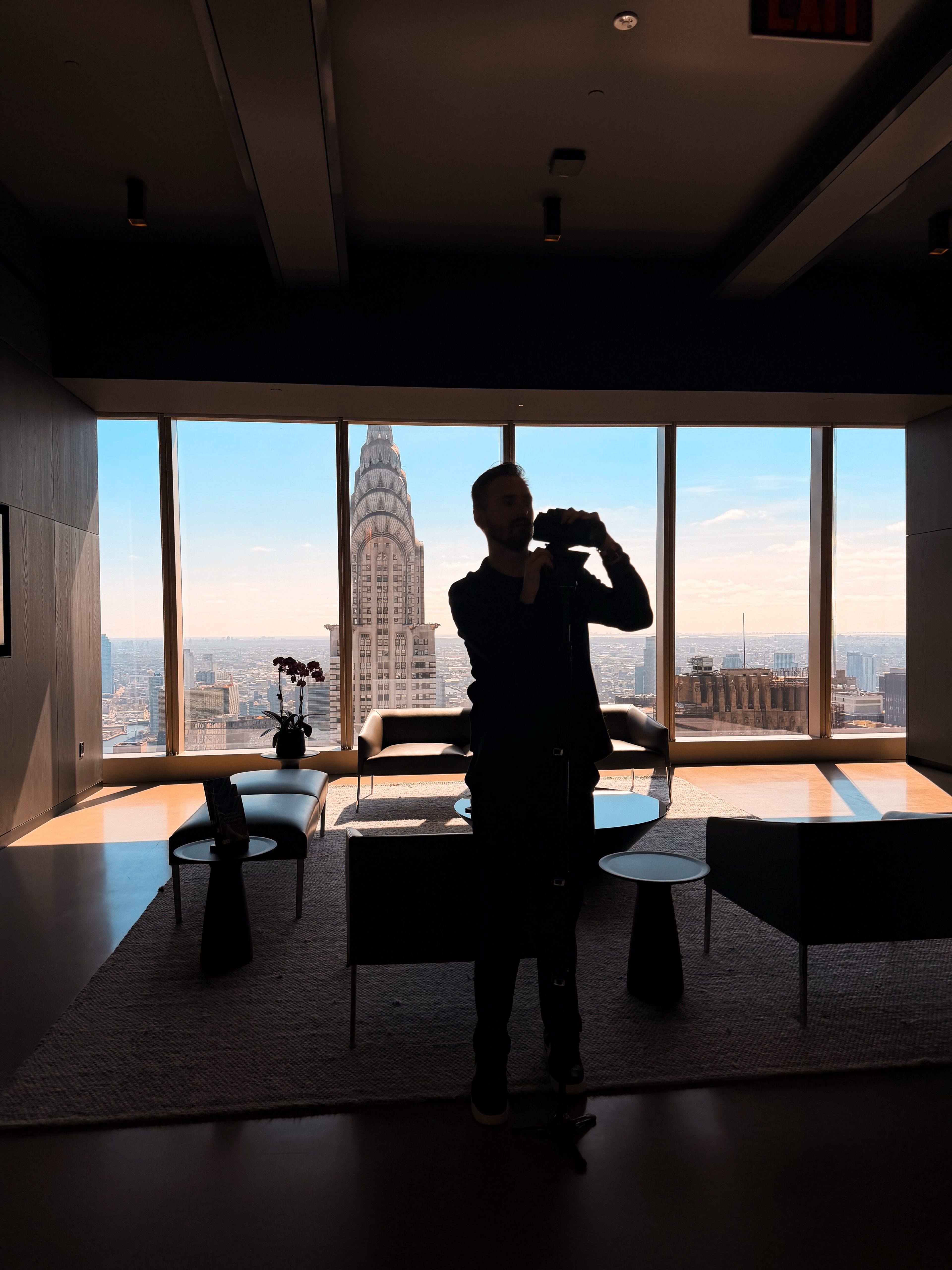 Silhouette of a camera operator filming the Chrysler Building view