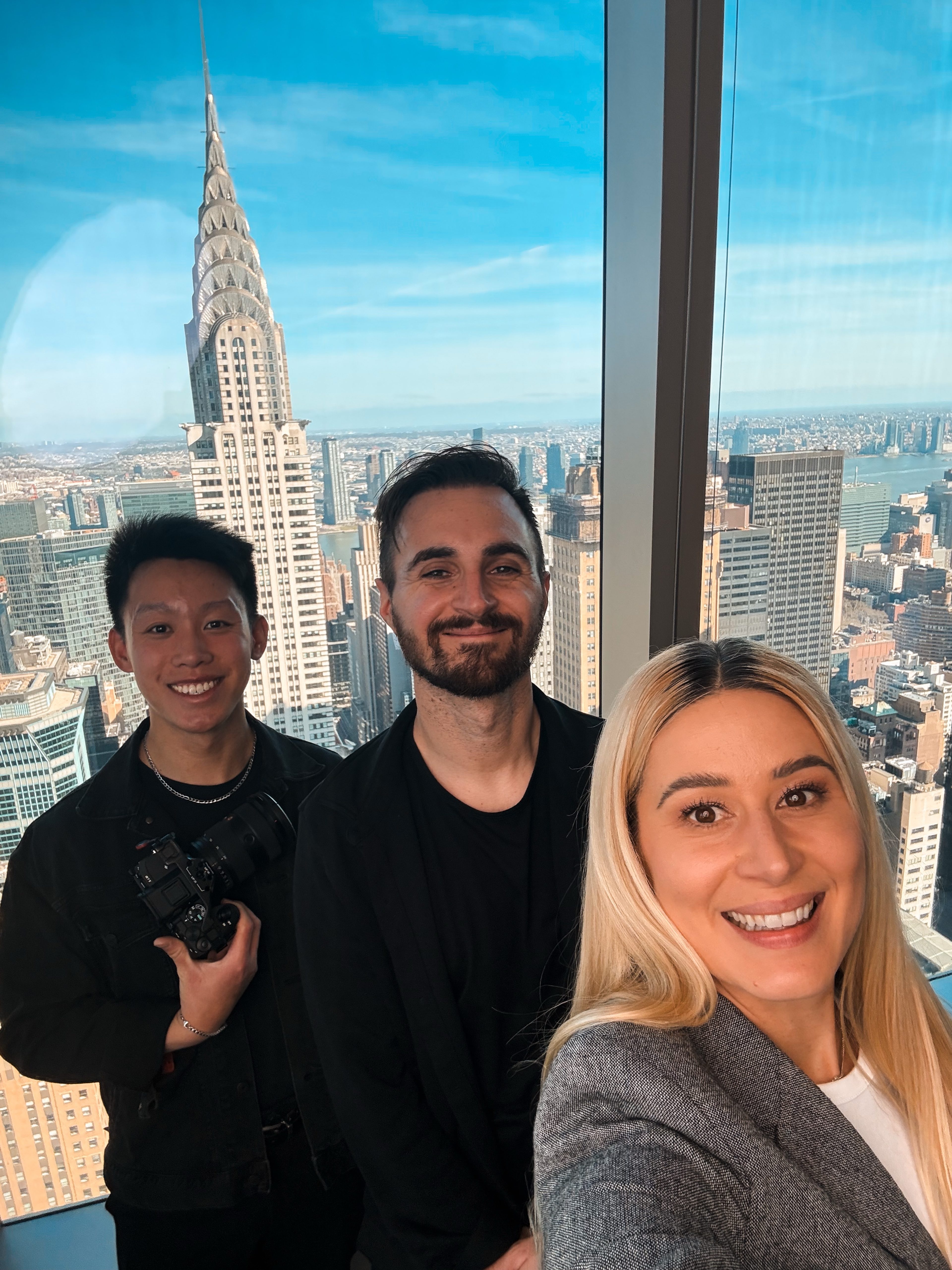 Crew selfie with the Chrysler Building in the window behind