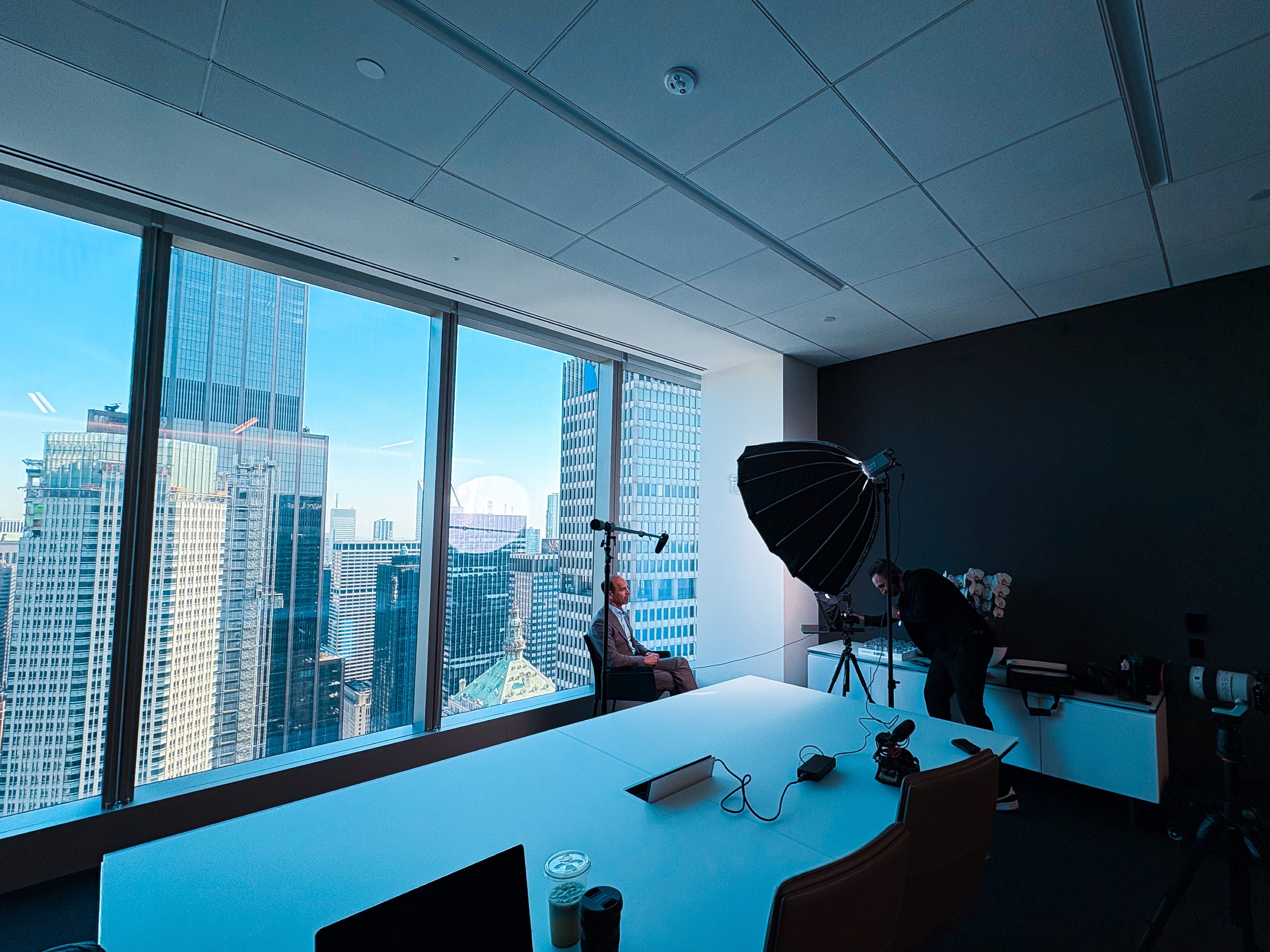 Lighting and camera setup in a conference room above Manhattan