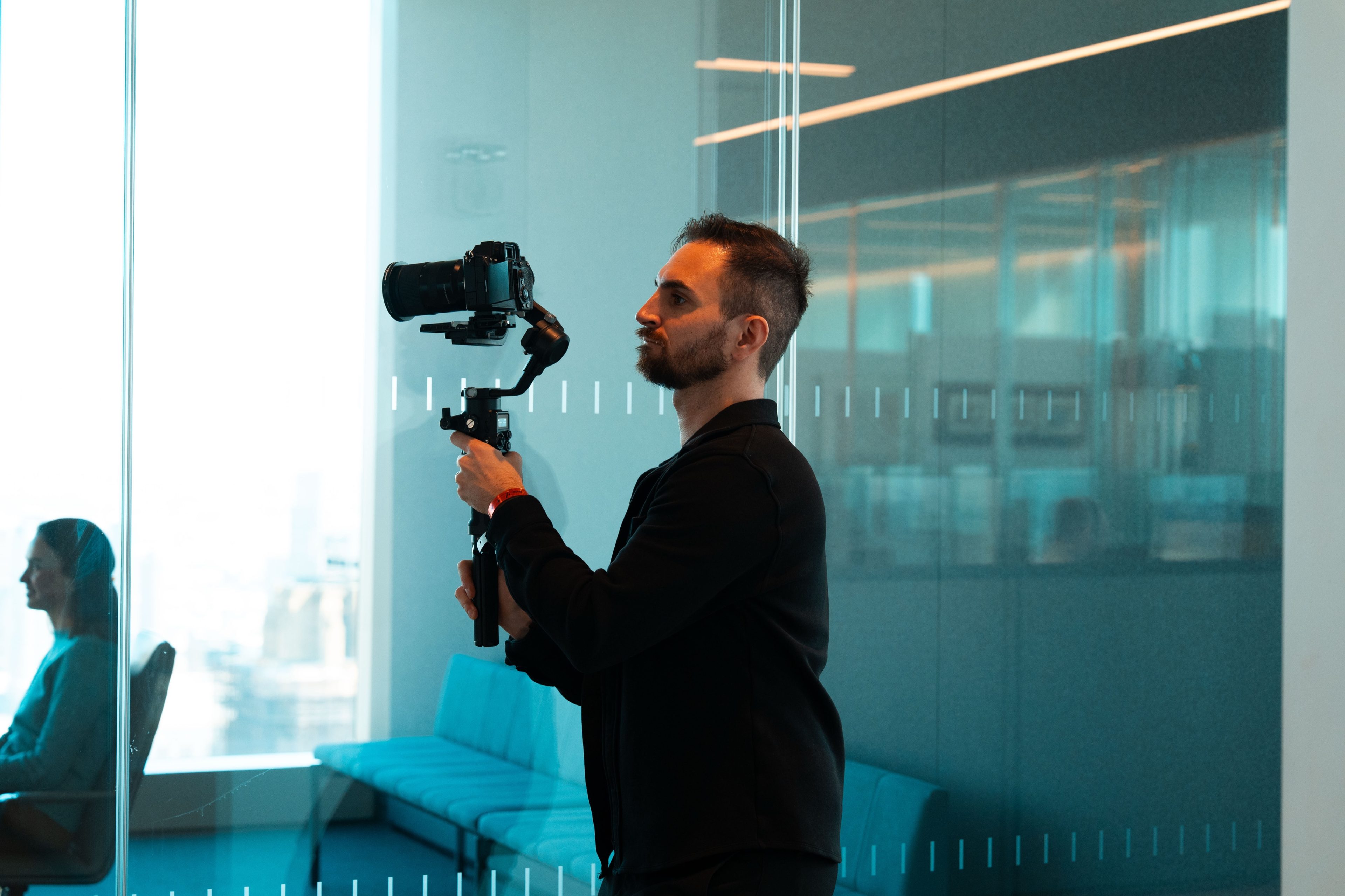 Camera operator with a gimbal rig in the office