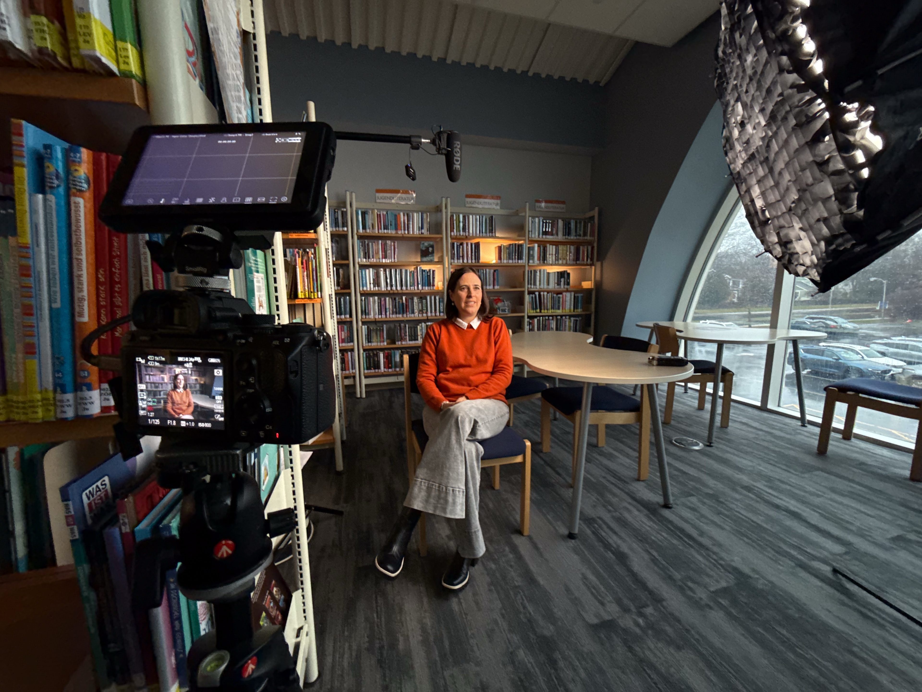 Interview in the school library, framed on the camera monitor