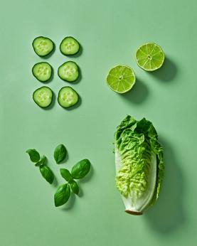 Grønne grønnsaker som salat, agurk, lime og urter.