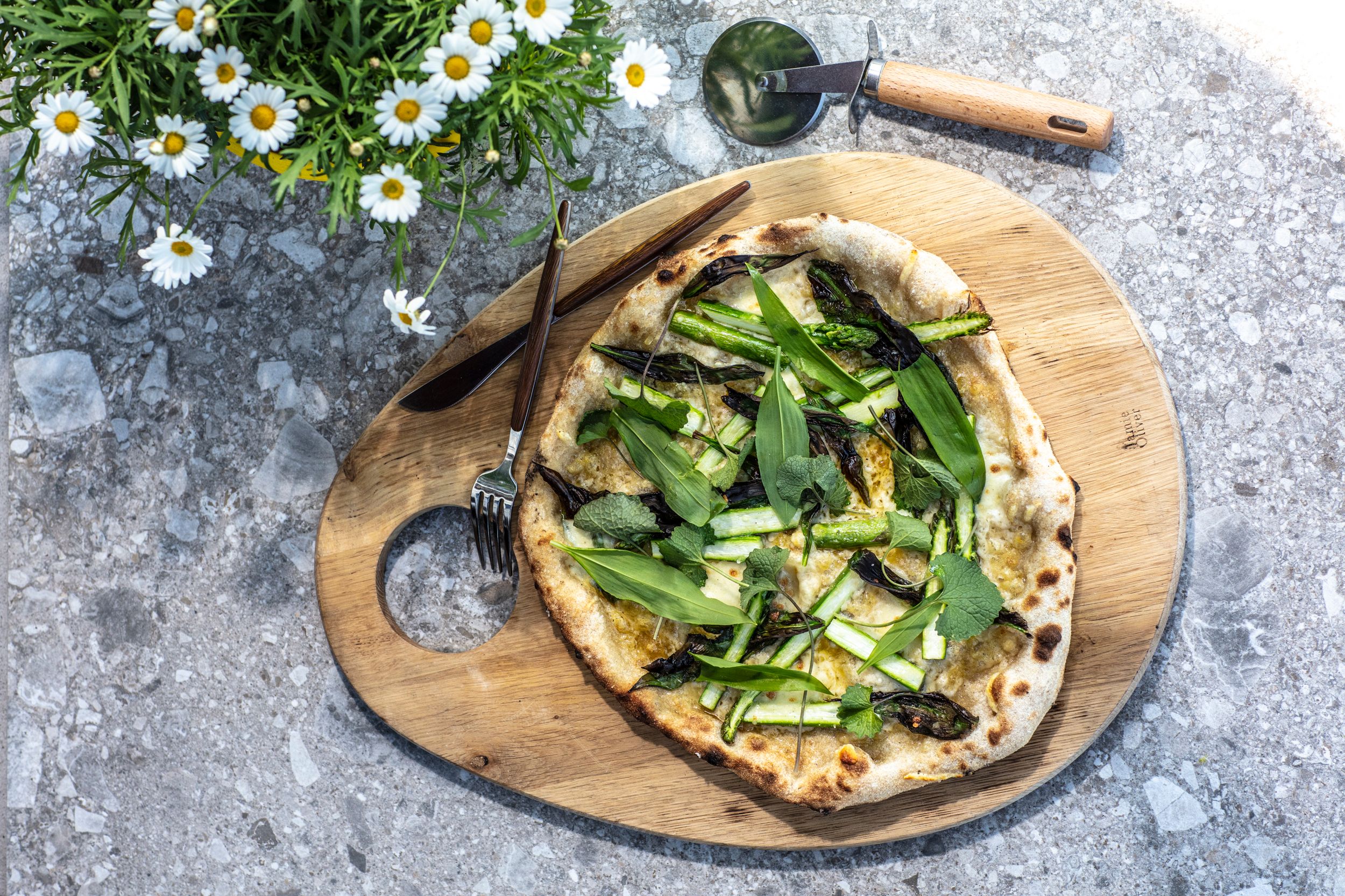 Bord med stekt pizza på en fjøl.