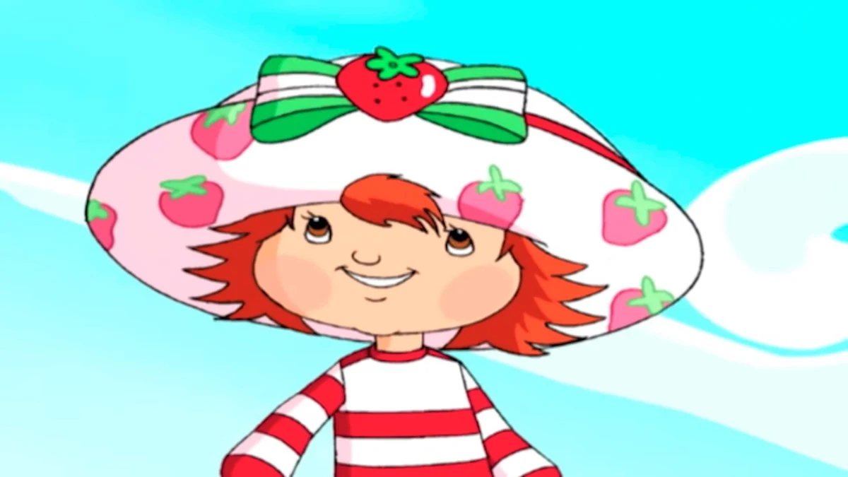 Classic Strawberry Shortcake smiles beneath her strawberry-patterned hat