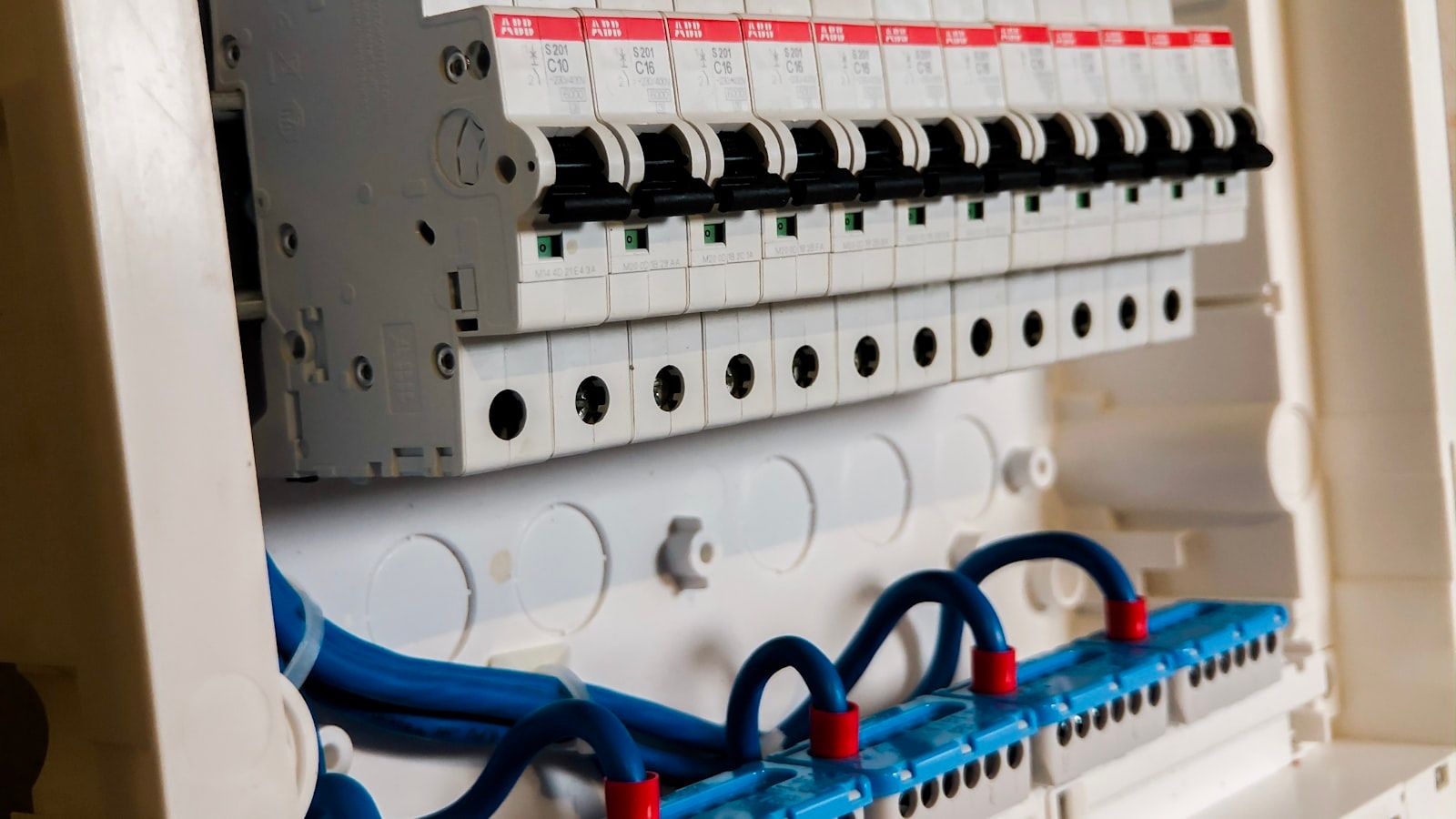 Industrial electrical panel with white circuit breakers — illustrating energy consumption analysis