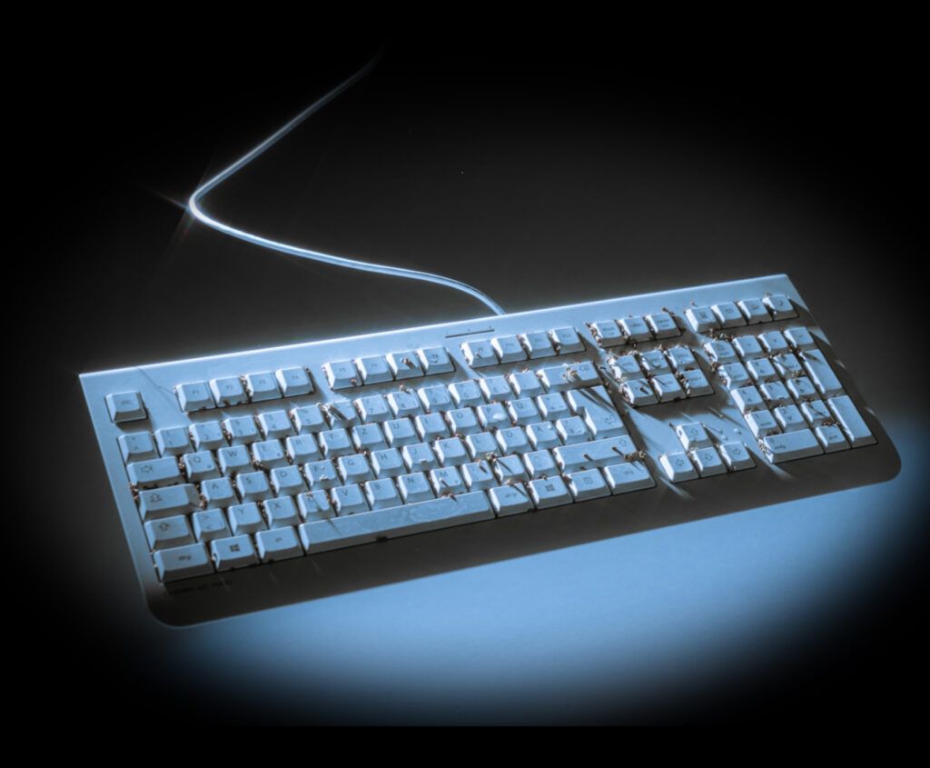 Mechanical keyboard floating in the air with plants growing from the keys