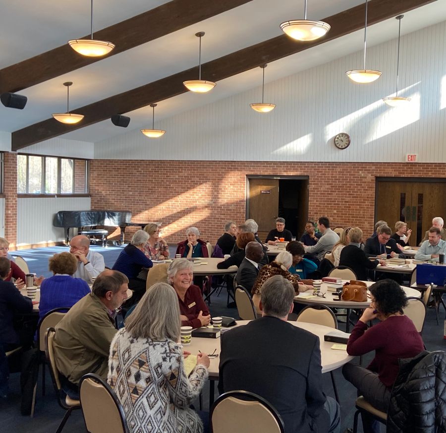 Adults fellowshipping at round tables