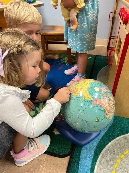 Day School Student exploring globe