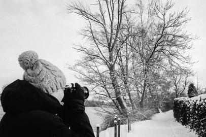 Taking pictures. Photographer capturing a winter scene.