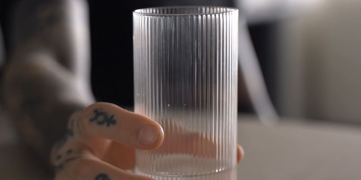 a man holding a glass of water