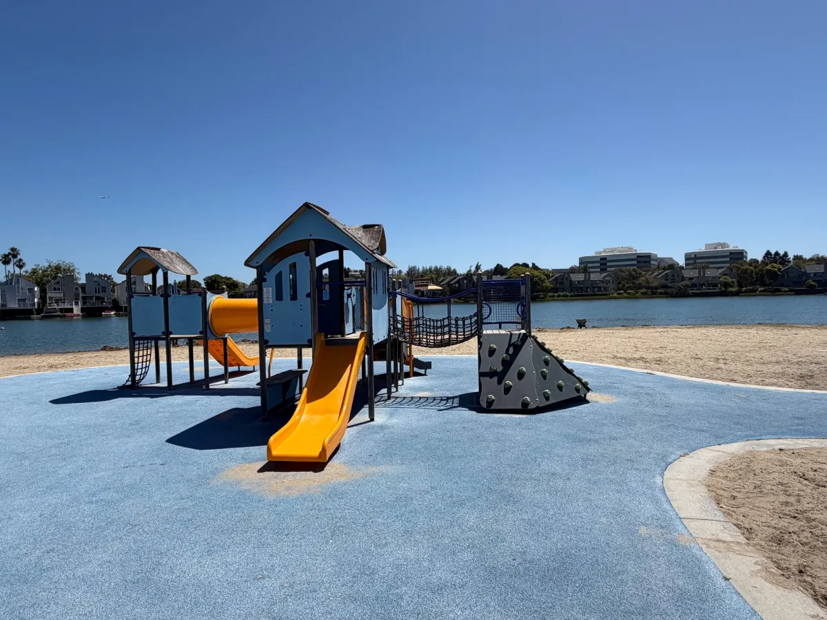 Toddler play structure with small climbing ramp and slides