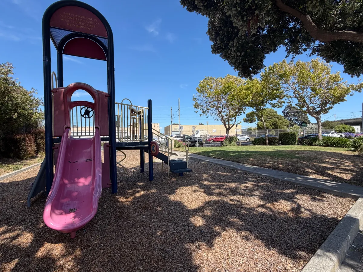 small grass area next to play equipment
