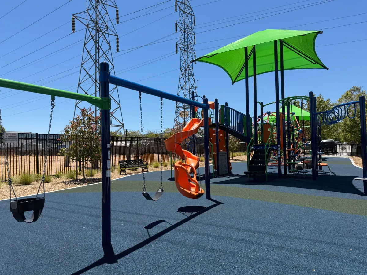Swings for both older and younger kids next to big kid zone