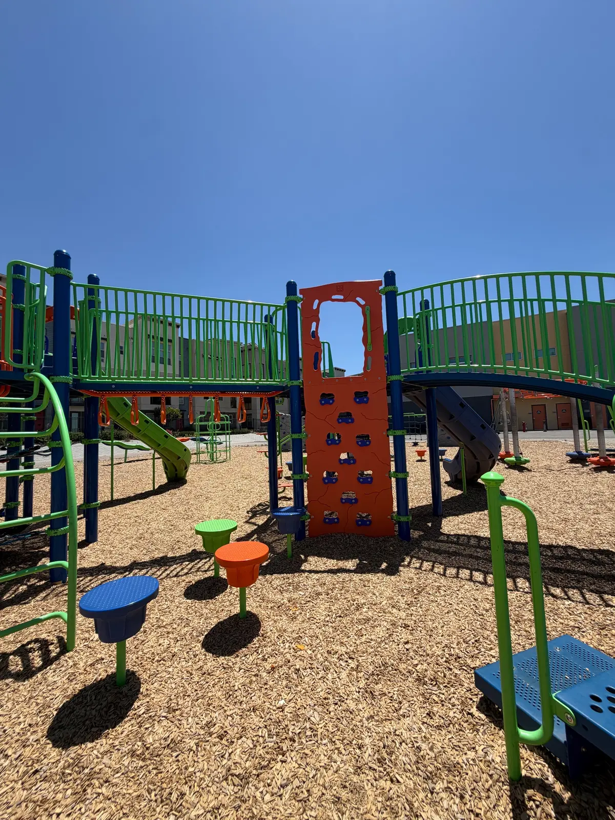 Big kid playground with bridges, rock wall, and stepping stones