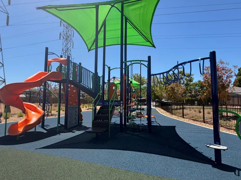 Monkey bars and slide in the big kid play structure