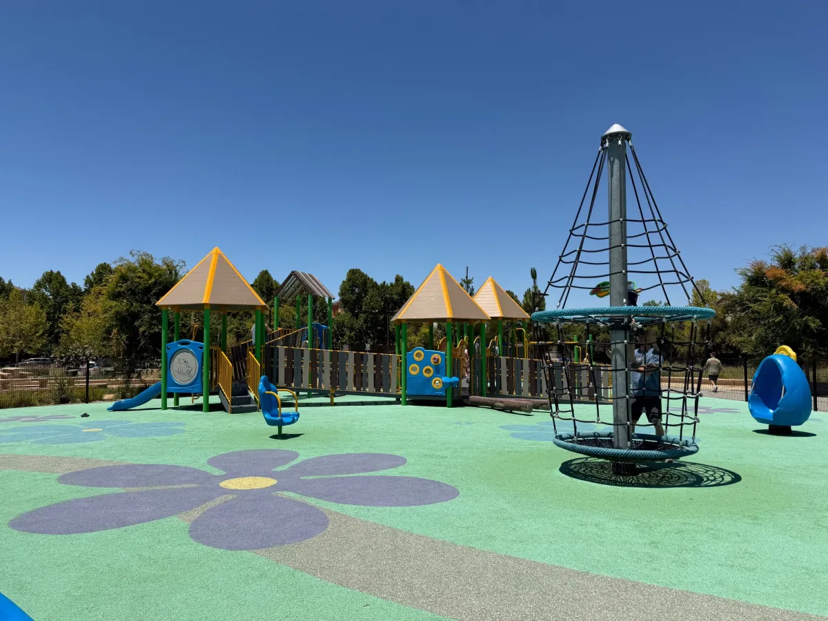 carousel and quiet pods in front of toddler play structure
