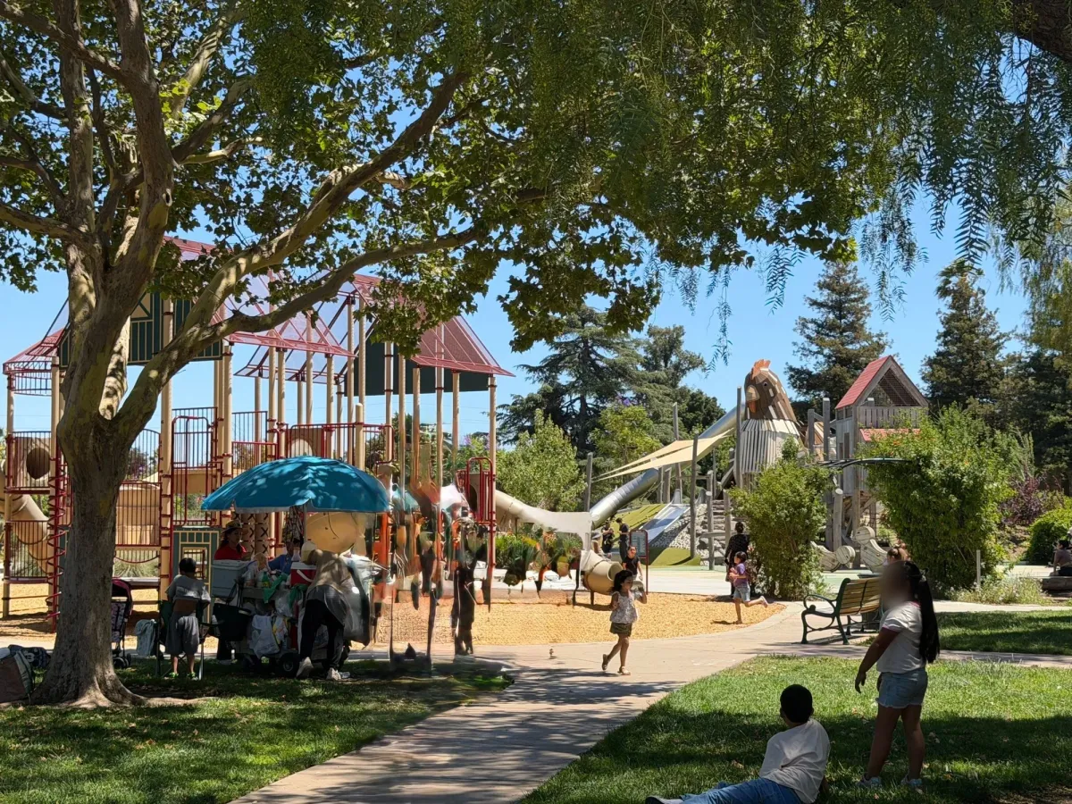 Food cart in front of big kid playground structure and chicken climbing structure in back