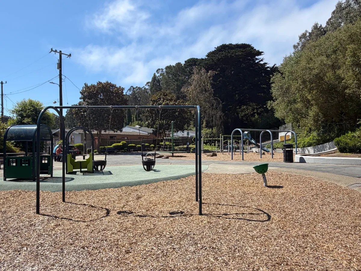 Toddler zone with baby swings, spinner, and playhouse
