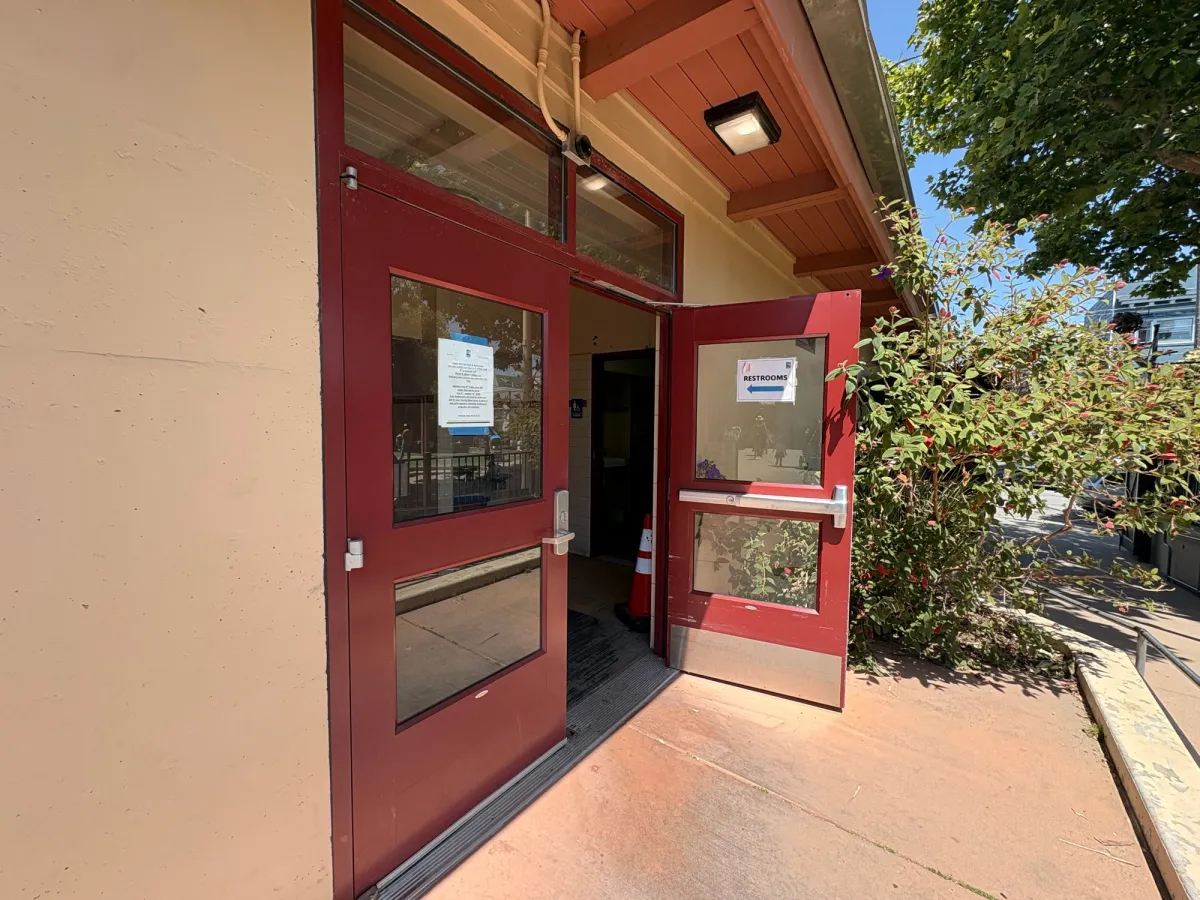 Bathroom entrance where both bathrooms have changing tables