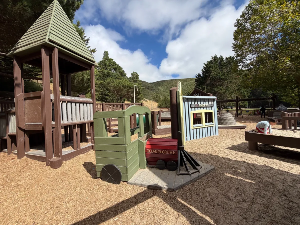 Train station and ticket booth to spark imaginative toddler play, sandpit on the side