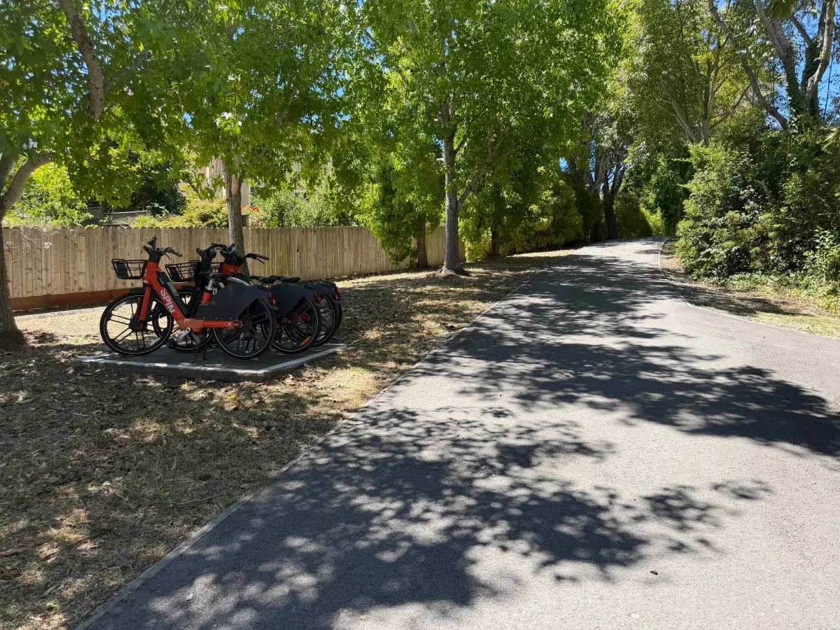 Spin bike share docking station nearby playground