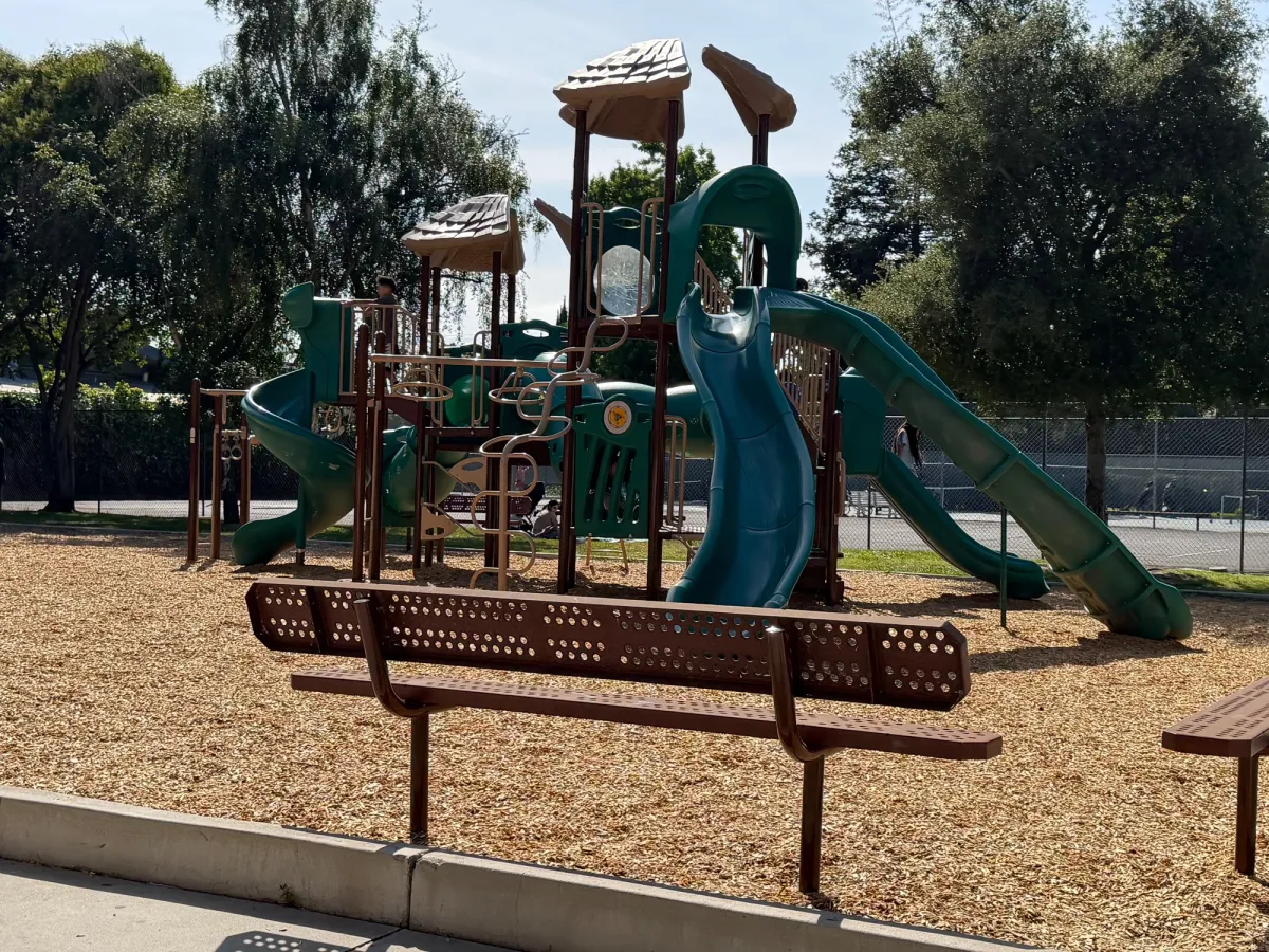 Big kid equipment with basketball court in back