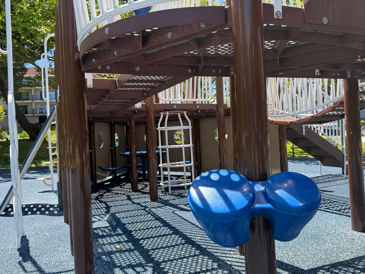 Picnic tables and sensory drums underneath ship