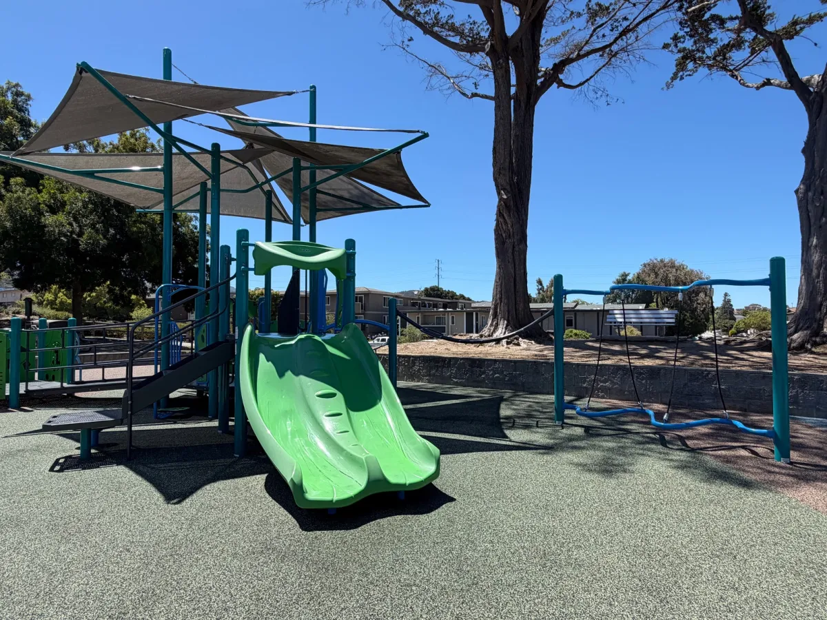 Toddler play area with mini slides, balance beam, and climbers