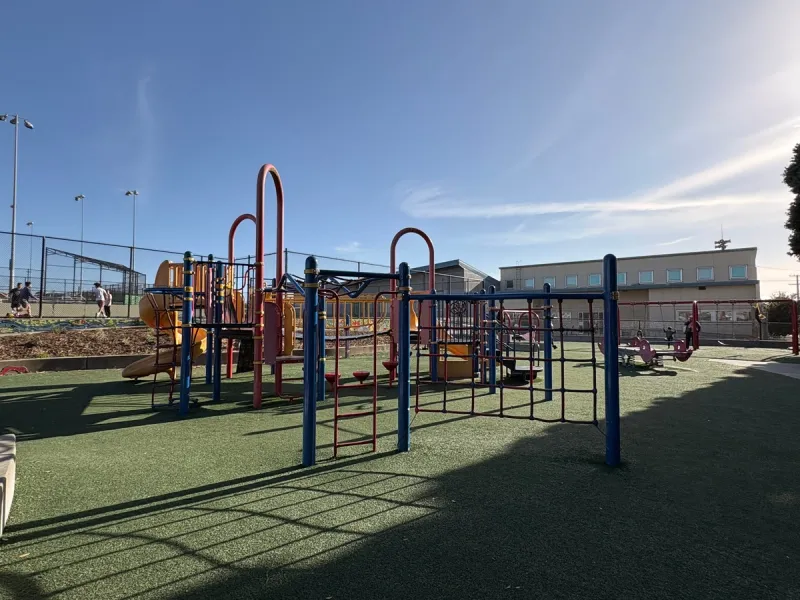 Wide shot of the playground at dusk