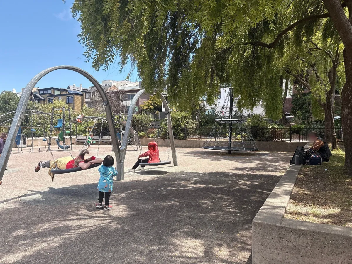 Shady area with fun swings and spinner