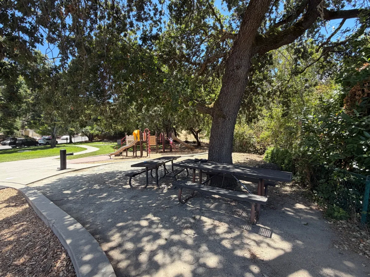 2 picnic tables to the side of the playground