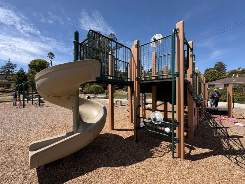 A playground structure that's got a fire engine theme