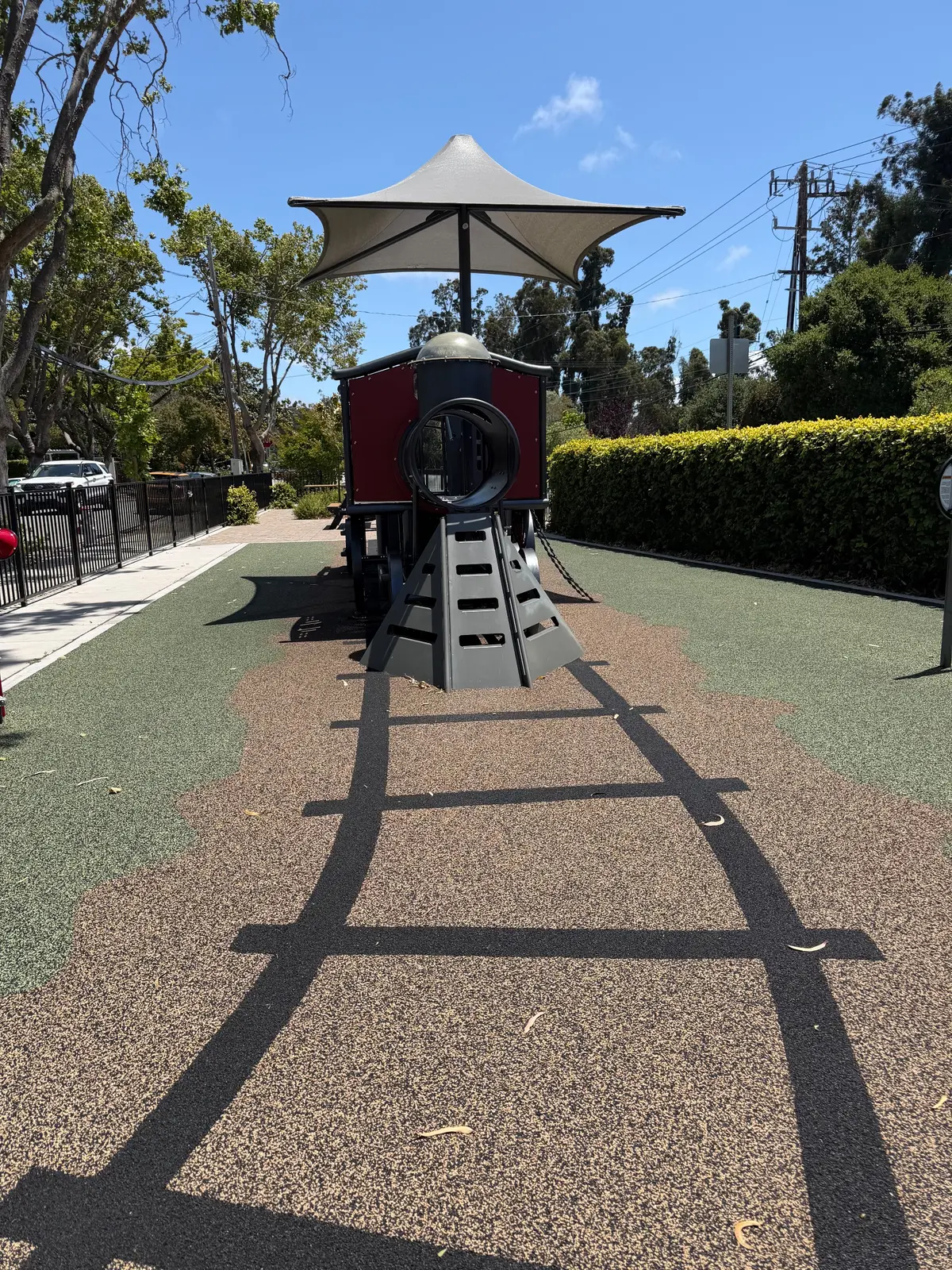 Train play structure on train tracks