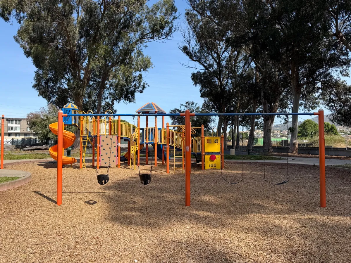 Big kid play structure on other side of park