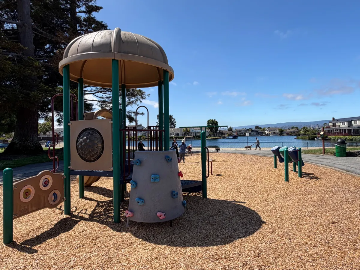 Toddler play structure with a backdrop of the water