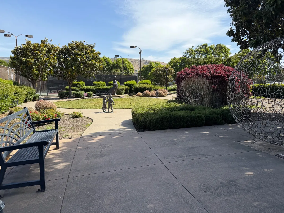 statue garden next to tennis courts