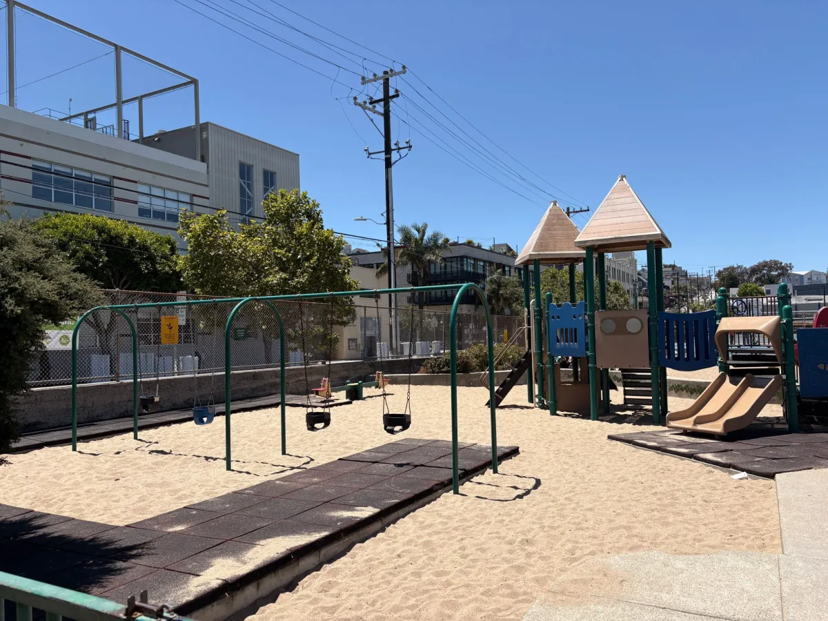Toddler area with bucket swings and smaller slides