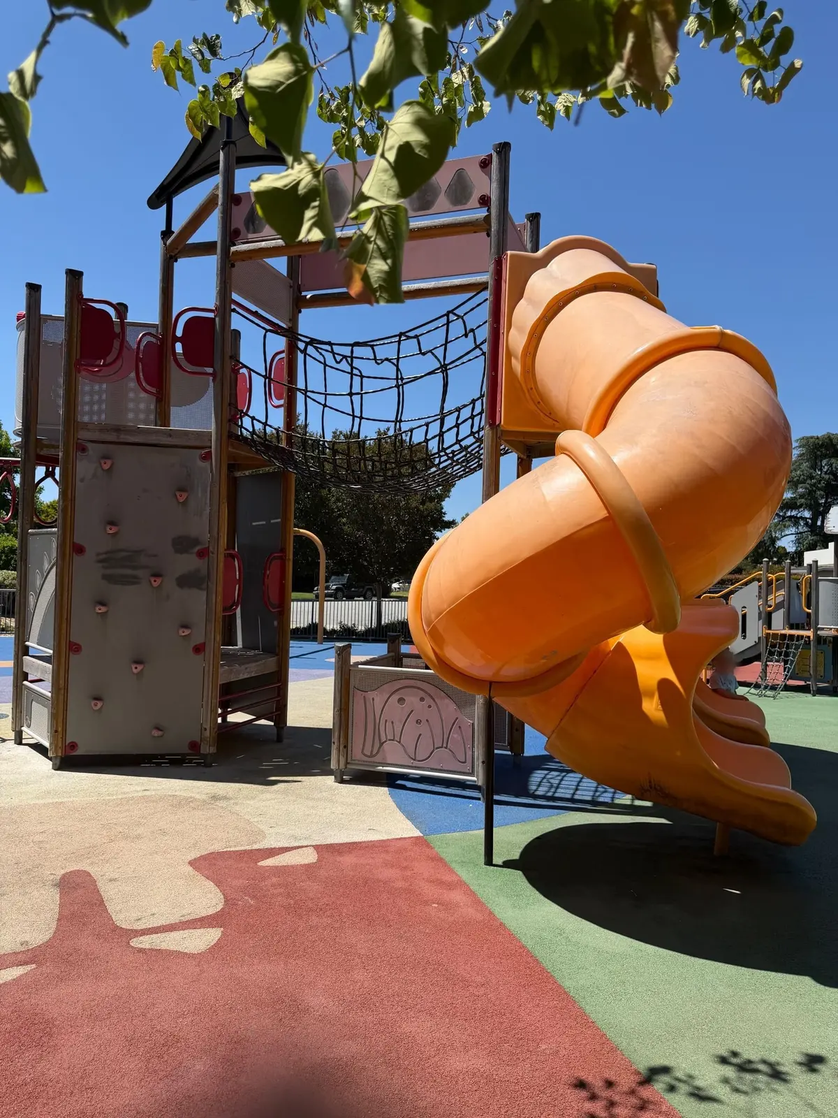 Big kid play structure slides and rock wall