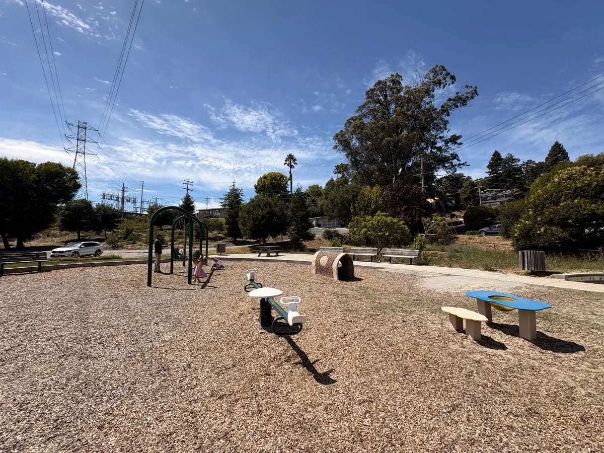 A sand table, teetertotter and a tunnel