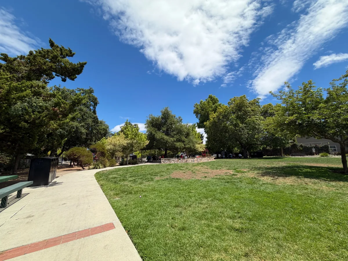 large grassy fields before getting to the playground