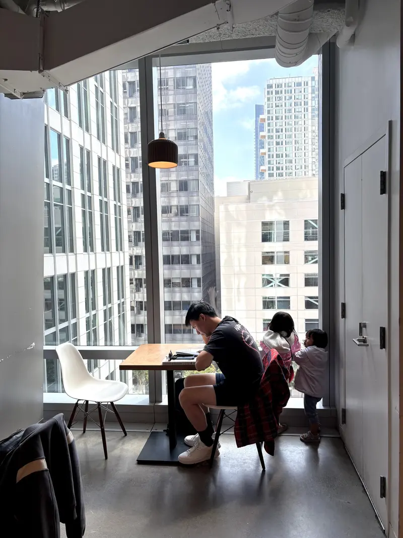 two kids looking out a window