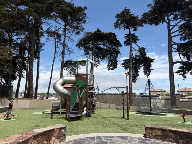 Big kid area complete with a tall slide, spinner, and multiple climbing areas