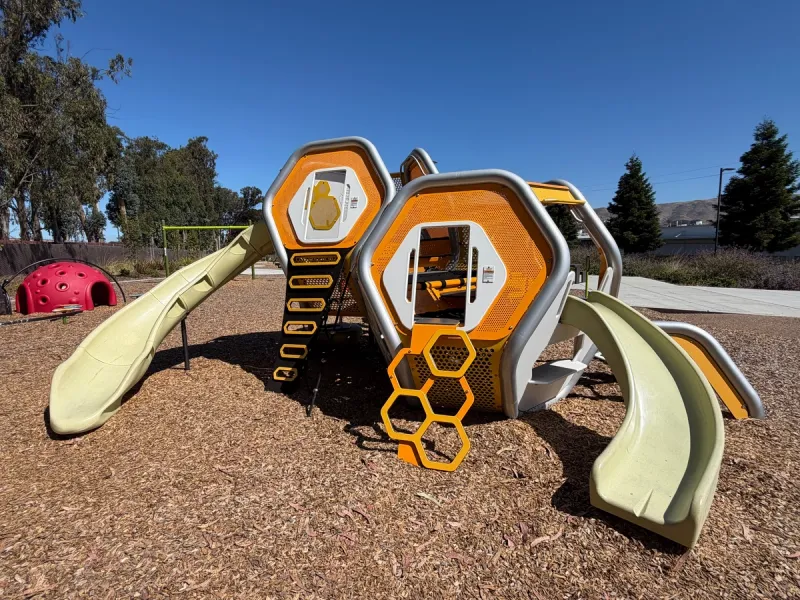 Toddler scaled slides and hideaway areas in the play structure