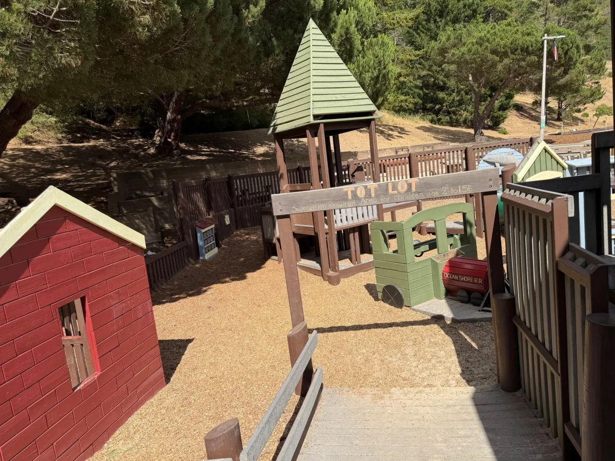 Entrance to toddler zone showcases a barn on the side and train station at entrance