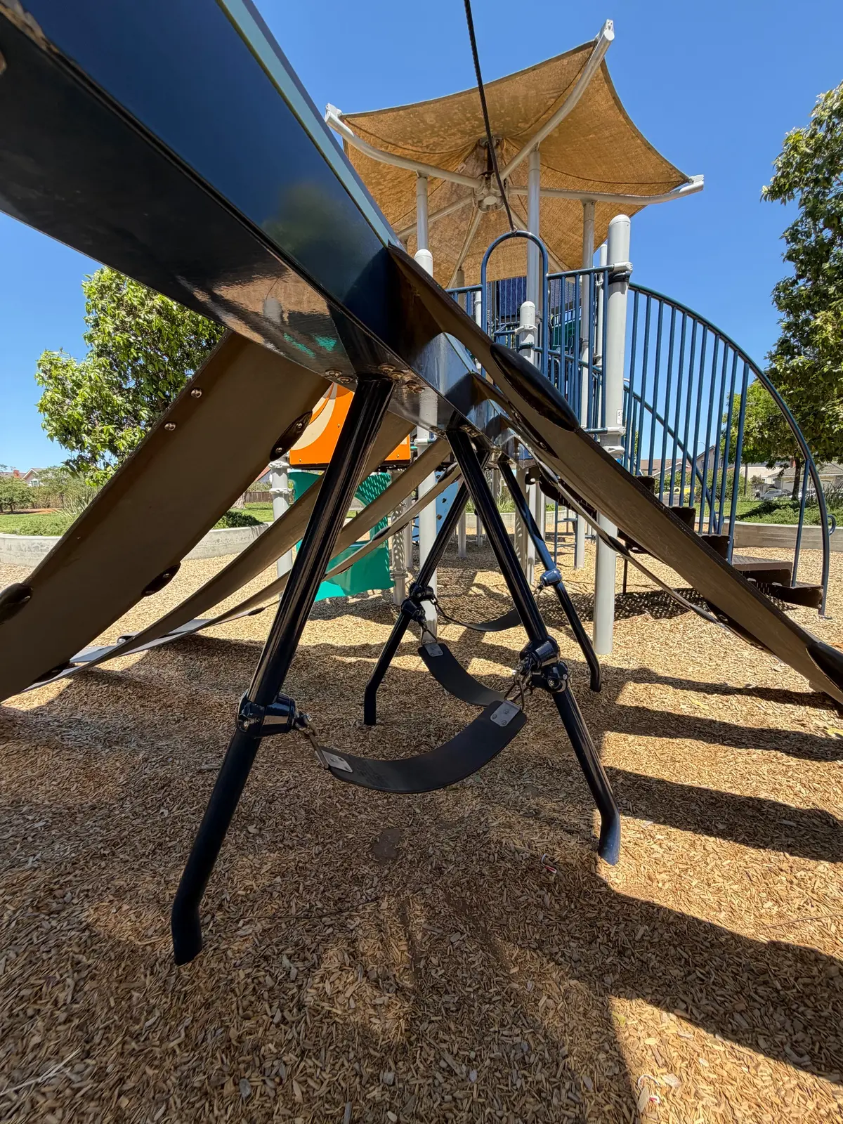 Big kid swings under play structure