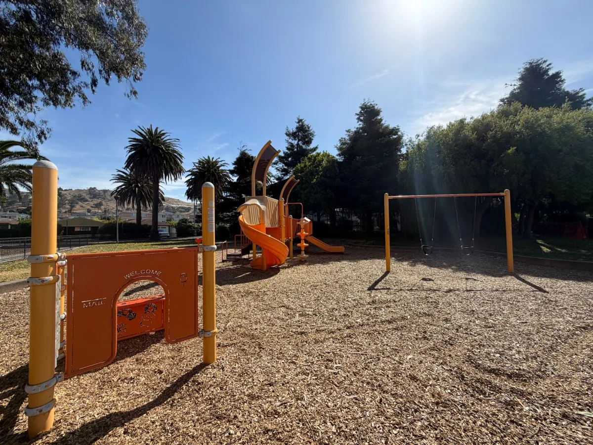 toddler play structure next to bigger kid structure